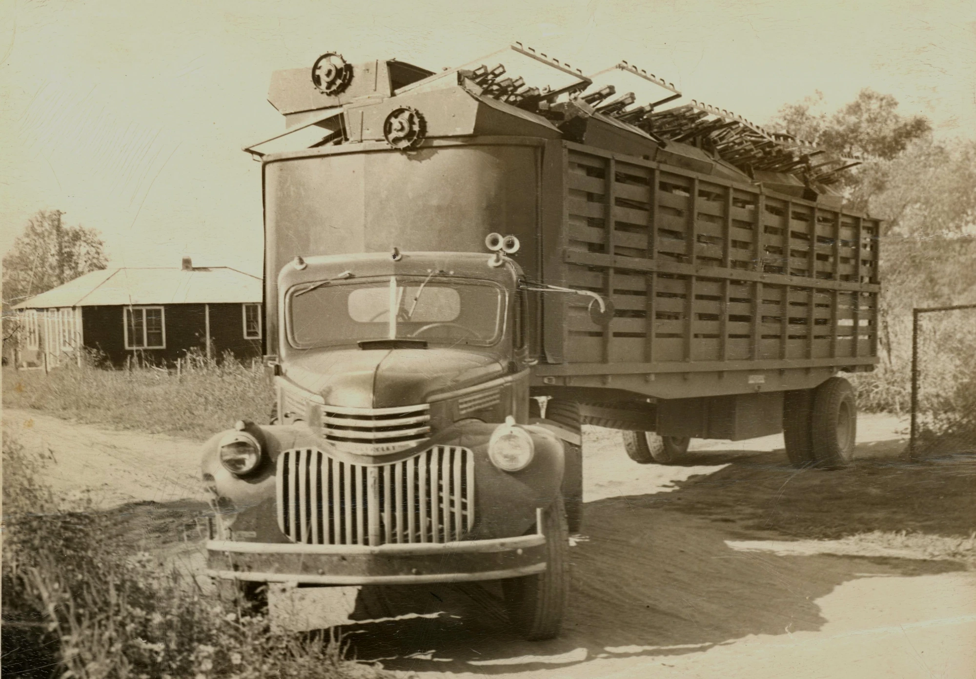Vintage B.E. Holbrooks Co. truck loaded with patented seed pan harvesters built in Stanfield, NC in the 1940s