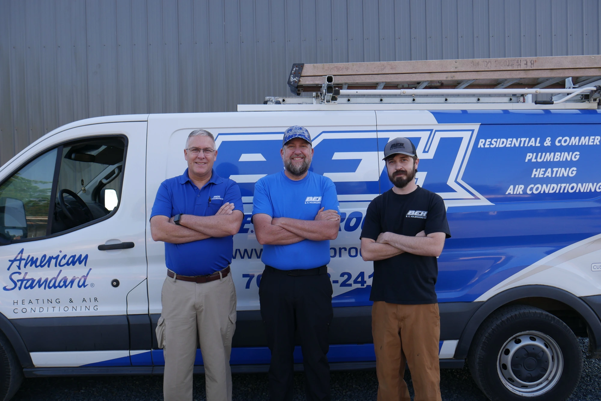 B.E. Holbrooks Co. service team standing in front of their American Standard HVAC and plumbing service van in Stanfield, NC